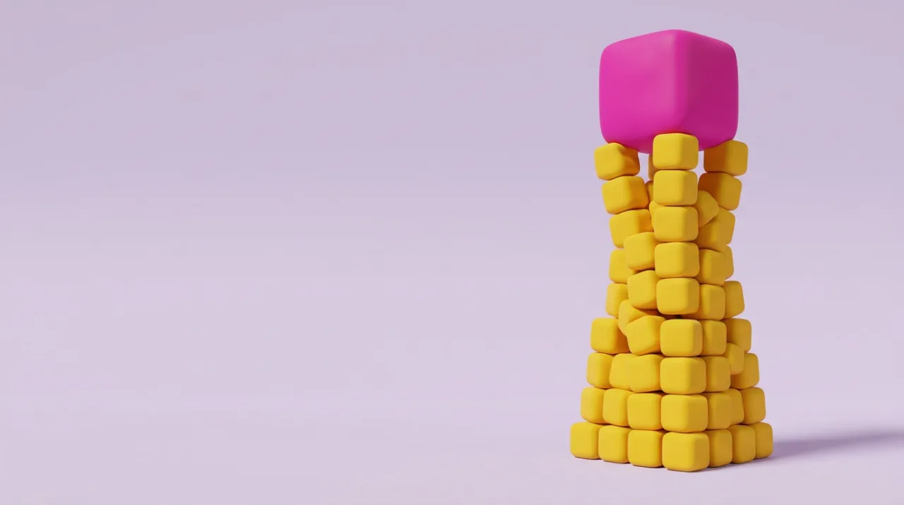A soft magenta block held up high by a tower of many small yellow cubes on a lilac backdrop